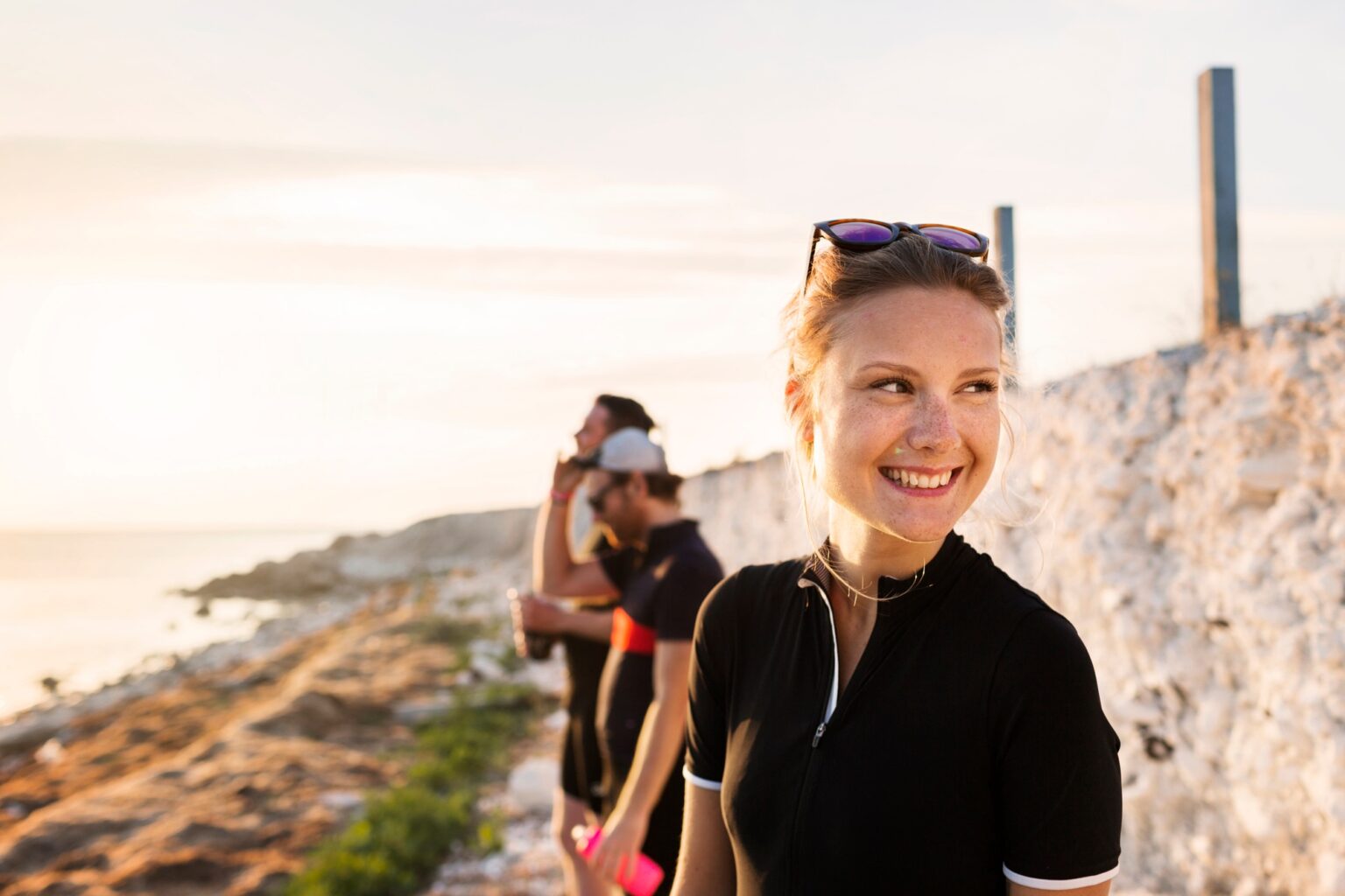Woman smiling, friends in background
